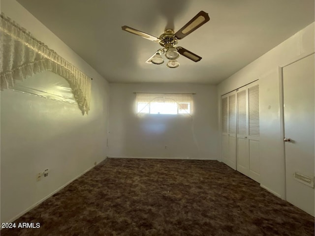 unfurnished bedroom with ceiling fan, a closet, and carpet