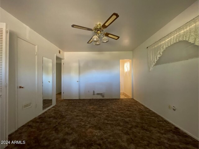 unfurnished bedroom with ceiling fan, a closet, and carpet