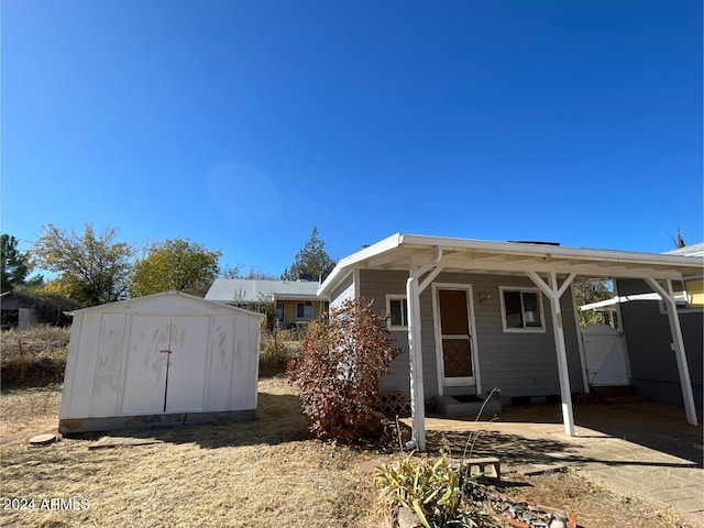 view of front of house with a shed