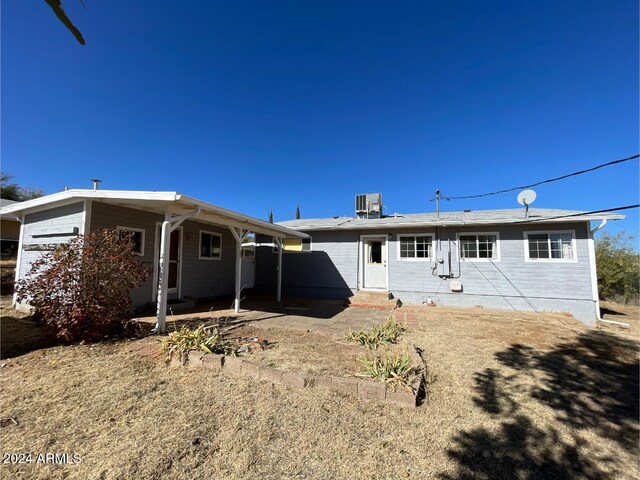 rear view of property with central air condition unit