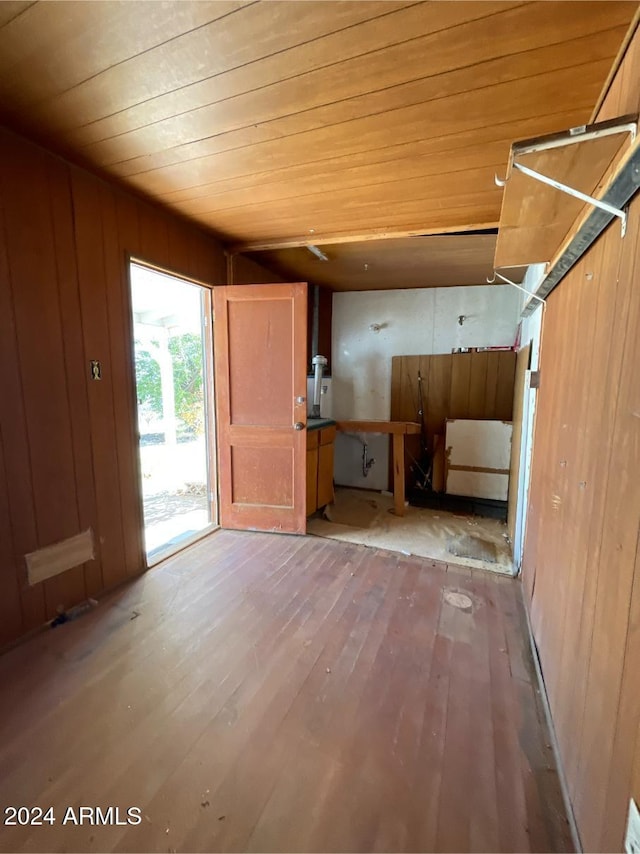 foyer featuring hardwood / wood-style floors, wooden ceiling, and wood walls