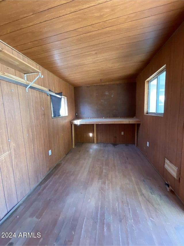 bonus room featuring wooden walls, light hardwood / wood-style floors, and wooden ceiling