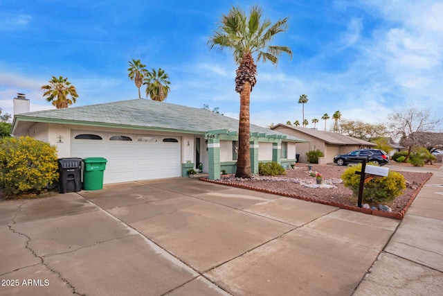 ranch-style home featuring a garage, driveway, and stucco siding