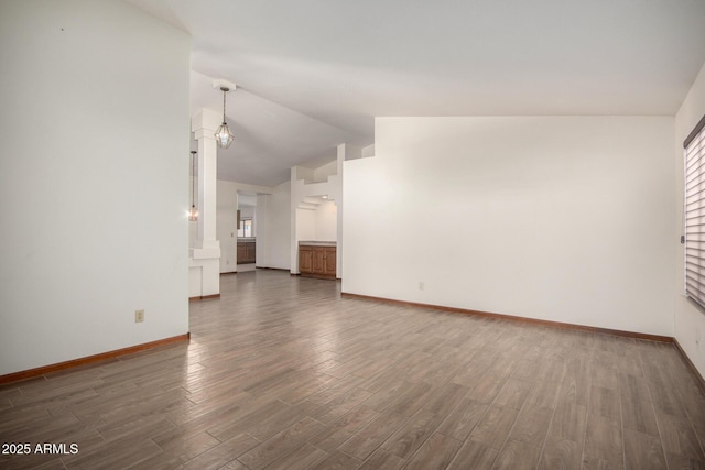 3740 W Kent Dr, Chandler, AZ 85226 - unfurnished living room featuring lofted ceiling, baseboards, and wood finished floors
