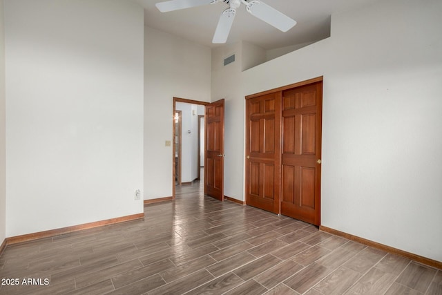 3740 W Kent Dr, Chandler, AZ 85226 - unfurnished bedroom featuring baseboards, wood finished floors, a towering ceiling, a ceiling fan, and a closet