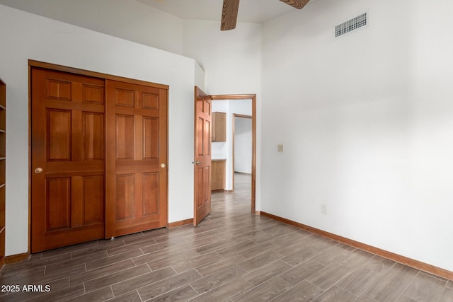 3740 W Kent Dr, Chandler, AZ 85226 - unfurnished bedroom featuring wood finished floors, baseboards, and a towering ceiling