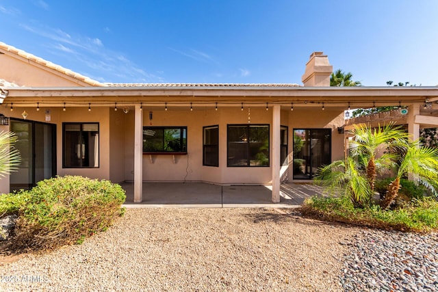 3740 W Kent Dr, Chandler, AZ 85226 - back of house featuring a patio, a chimney, and stucco siding