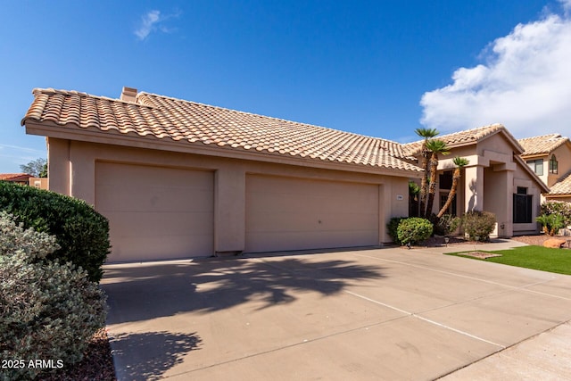 3740 W Kent Dr, Chandler, AZ 85226 - view of front of house featuring an attached garage, a tiled roof, stucco siding, and driveway