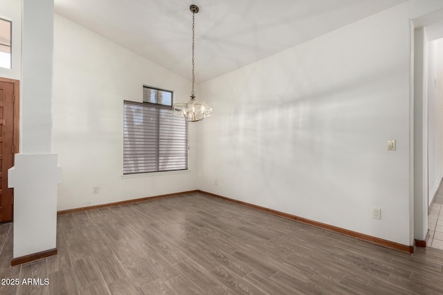 3740 W Kent Dr, Chandler, AZ 85226 - unfurnished dining area featuring a chandelier, wood finished floors, lofted ceiling, and baseboards