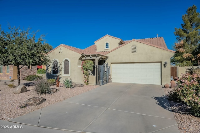 mediterranean / spanish-style house with a garage