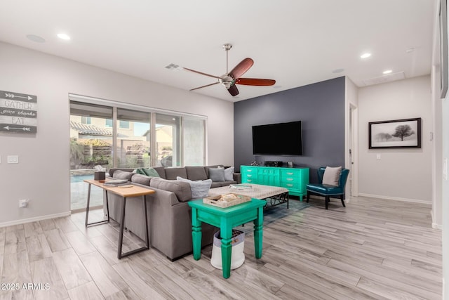 living room with light wood-style floors, baseboards, a ceiling fan, and recessed lighting