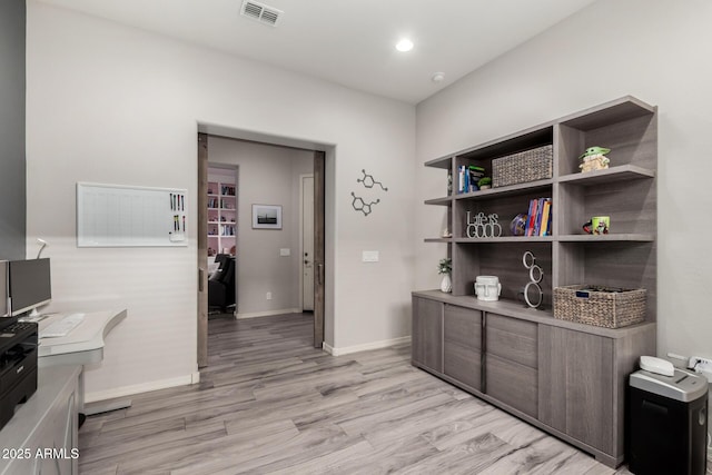 interior space featuring light wood-style floors, baseboards, visible vents, and recessed lighting