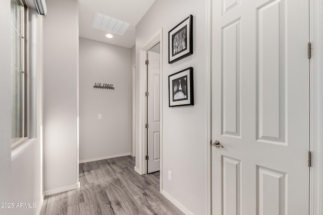 hallway featuring recessed lighting, visible vents, light wood-style flooring, and baseboards