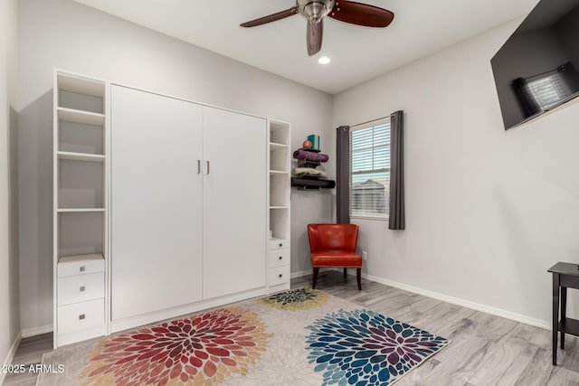 sitting room featuring a ceiling fan, recessed lighting, baseboards, and wood finished floors