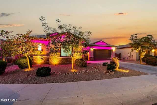 view of front of home with driveway, an attached garage, and stucco siding