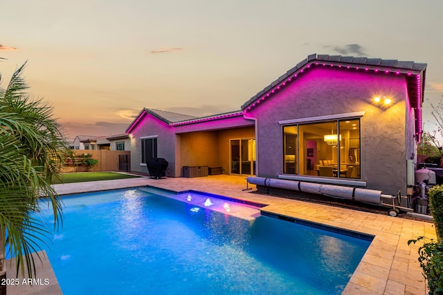 view of pool featuring a patio, area for grilling, fence, and a fenced in pool