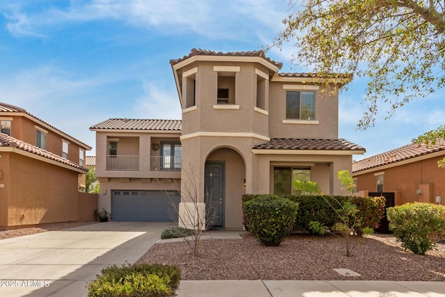 mediterranean / spanish home featuring a garage, driveway, a tile roof, and stucco siding