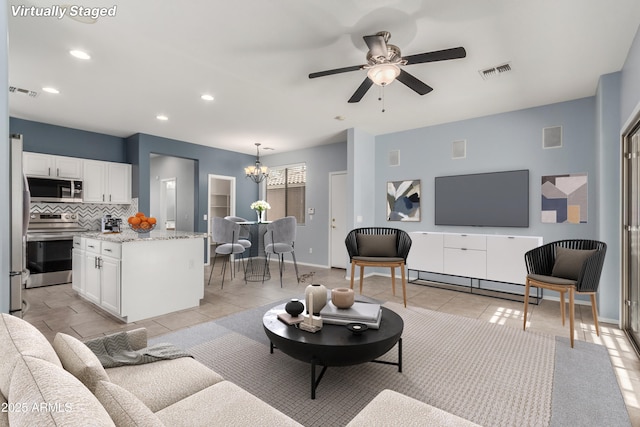 3891 E Melrose St, Gilbert, AZ 85297 - living room featuring recessed lighting, visible vents, light tile patterned floors, and ceiling fan with notable chandelier