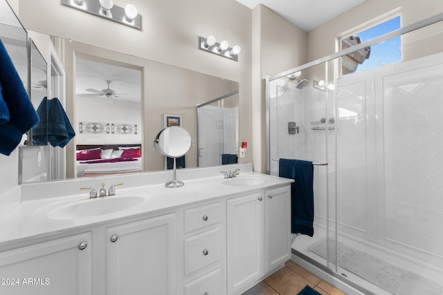 bathroom with tile patterned floors, ceiling fan, a shower with shower door, and vanity