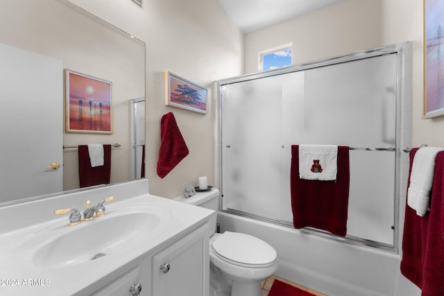 full bathroom featuring combined bath / shower with glass door, vanity, and toilet