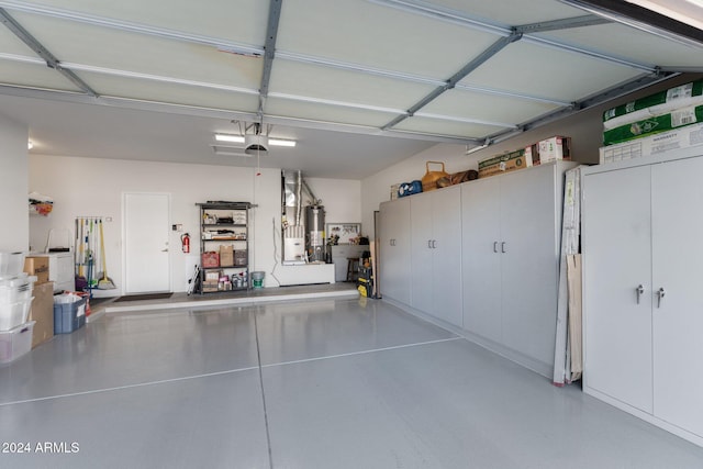 garage featuring a garage door opener and water heater