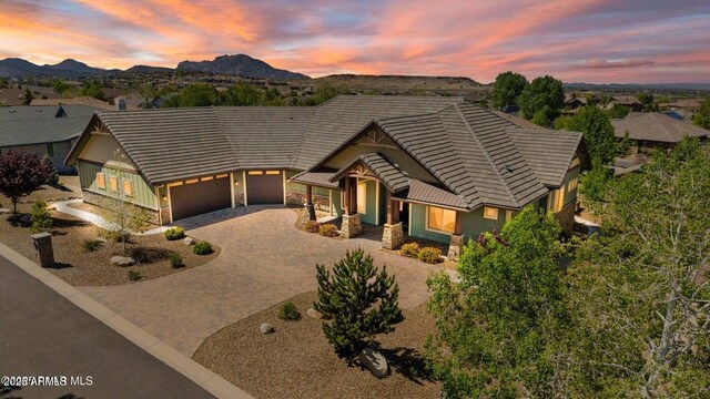 1568 Gettysvue Way, Prescott, AZ 86301 - view of front of house featuring stone siding, driveway, a garage, and a tiled roof