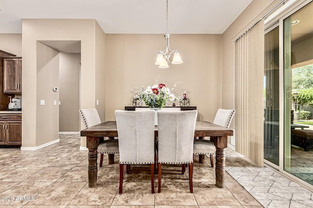 7242 W Rowel Rd, Peoria, AZ 85383 - dining area with a chandelier and light tile patterned flooring