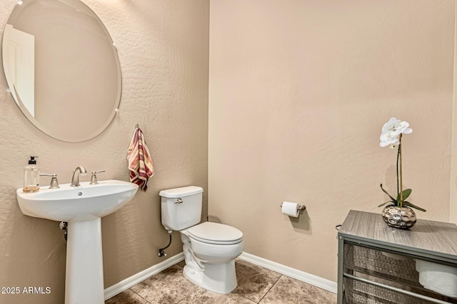 7242 W Rowel Rd, Peoria, AZ 85383 - half bath featuring toilet and tile patterned flooring