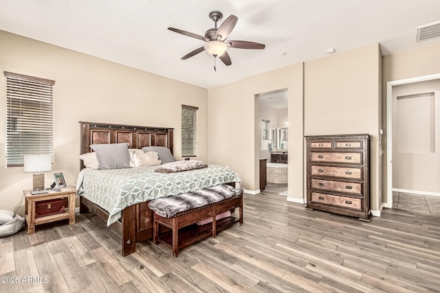 7242 W Rowel Rd, Peoria, AZ 85383 - bedroom featuring light wood-style flooring, connected bathroom, and ceiling fan