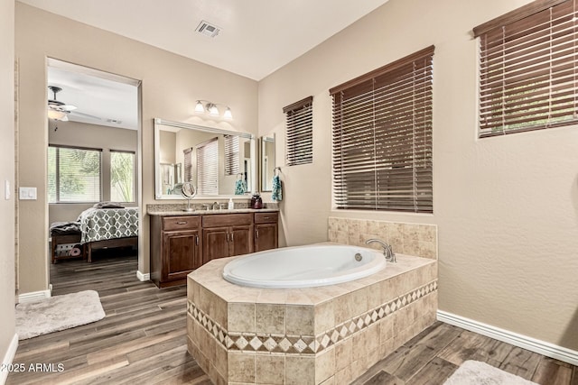 7242 W Rowel Rd, Peoria, AZ 85383 - bathroom with a garden tub, vanity, wood finished floors, ensuite bath, and ceiling fan