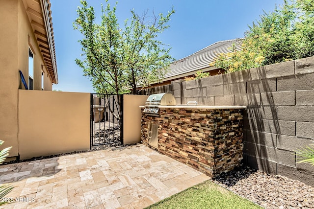 7242 W Rowel Rd, Peoria, AZ 85383 - view of patio featuring an outdoor kitchen and a gate
