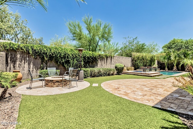 7242 W Rowel Rd, Peoria, AZ 85383 - fenced backyard featuring a fire pit and a patio area