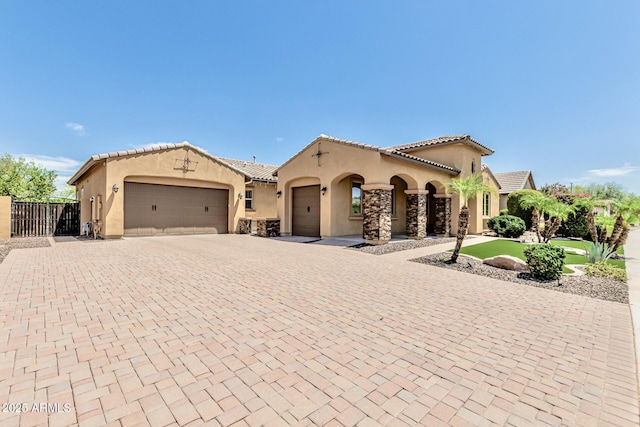 7242 W Rowel Rd, Peoria, AZ 85383 - mediterranean / spanish-style house featuring stucco siding, an attached garage, decorative driveway, and a tiled roof