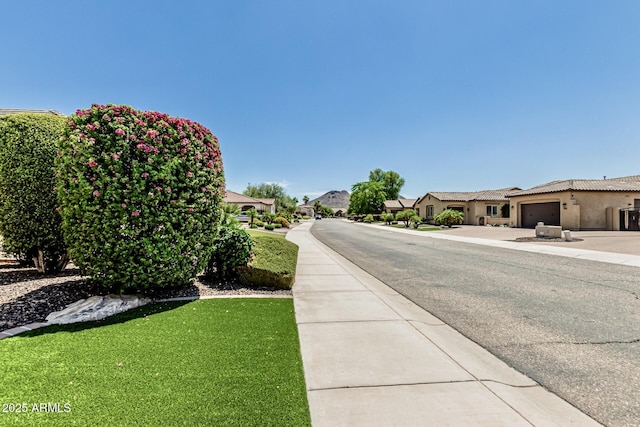 7242 W Rowel Rd, Peoria, AZ 85383 - view of asphalt street with sidewalks and a residential view