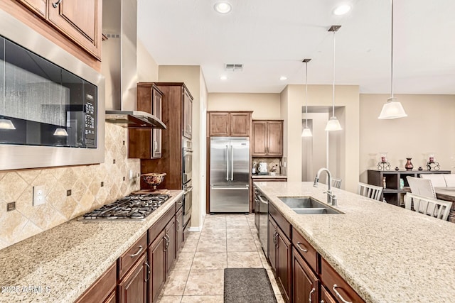 7242 W Rowel Rd, Peoria, AZ 85383 - kitchen featuring built in appliances, wall chimney exhaust hood, decorative light fixtures, decorative backsplash, and light stone counters