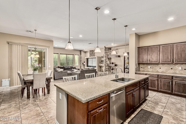 7242 W Rowel Rd, Peoria, AZ 85383 - kitchen with tasteful backsplash, a kitchen island with sink, recessed lighting, stainless steel dishwasher, and light stone countertops