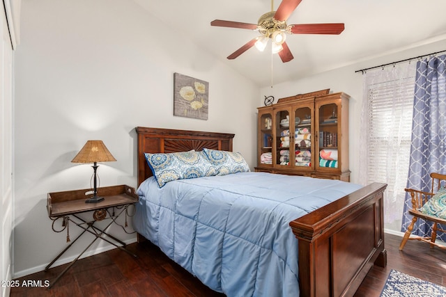 bedroom with lofted ceiling, ceiling fan, and dark wood-type flooring