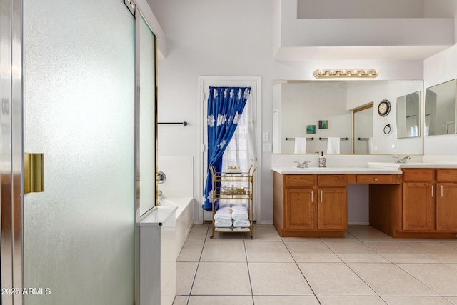 bathroom with tile patterned floors, vanity, and separate shower and tub