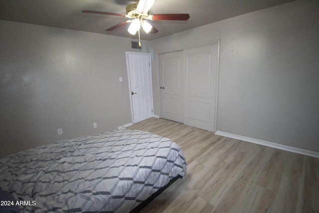 bedroom featuring a closet, ceiling fan, and light hardwood / wood-style flooring