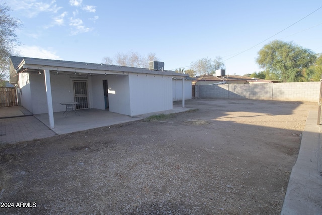 back of house with central air condition unit, ceiling fan, and a patio