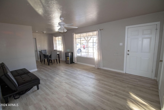 interior space featuring a textured ceiling, light hardwood / wood-style flooring, and ceiling fan