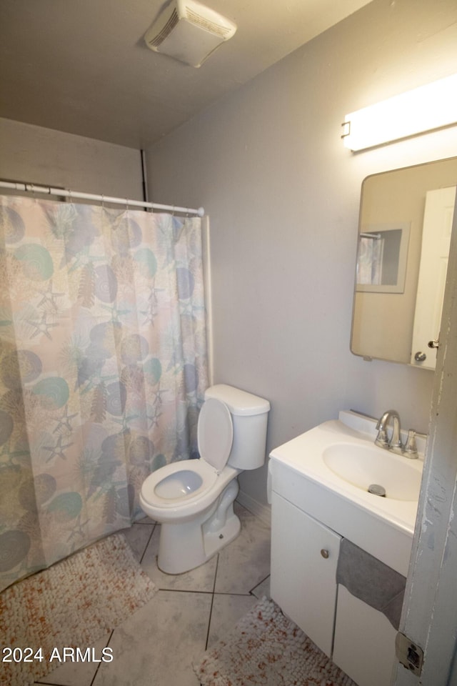 bathroom featuring tile patterned floors, vanity, and toilet