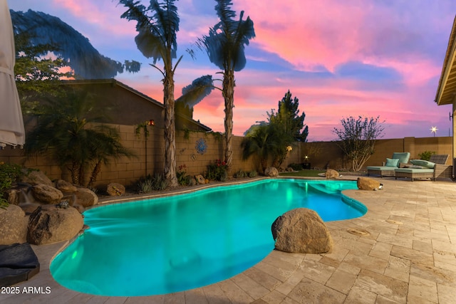 view of pool featuring a patio area and a fenced backyard