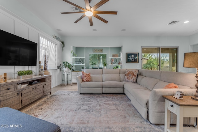 living area featuring ceiling fan, plenty of natural light, recessed lighting, and light wood-style flooring