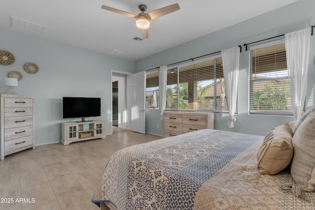 bedroom with light wood-style flooring, baseboards, and a ceiling fan