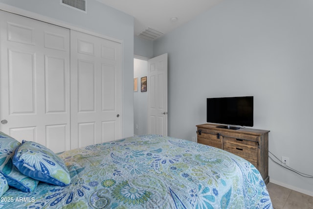 tiled bedroom with a closet