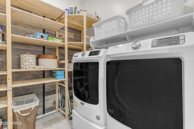 clothes washing area featuring separate washer and dryer