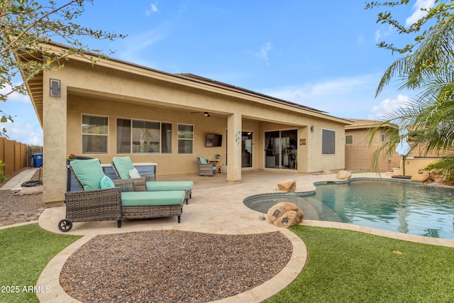rear view of house with stucco siding, a patio, and a fenced backyard