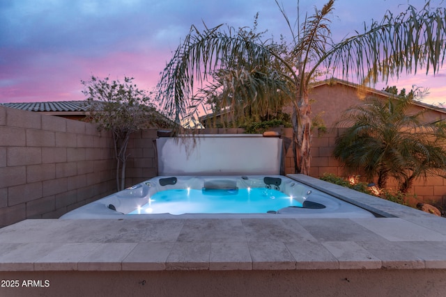 view of swimming pool with a covered hot tub and a fenced backyard