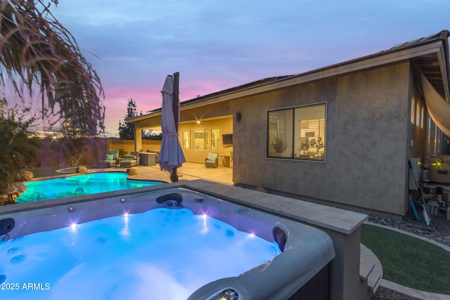 view of pool with a hot tub and a fenced backyard